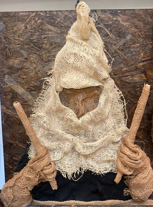 Handcrafted witch figure on wood, unique decorative sculpture for home.